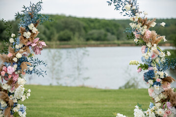 wedding arch at an outdoor ceremony from natural flowers