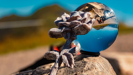 Crystal ball alpine landscape shot with a stone rose at the famous Kanzelwand summit, Kleinwalsertal valley, Riezlern, Vorarlberg, Austria