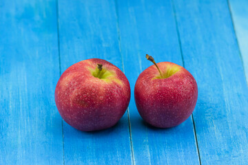 close-up apple on blue wooden background