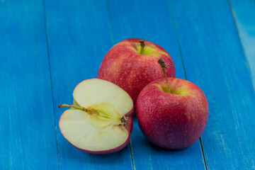 close-up apple on blue wooden background