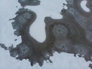 Aerial shot of the frozen lake special surface formations on a cold winter day - 558754615