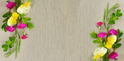 Pattern of phlox and violets on a beautiful gray background. There is a place for the text . Wide photo.