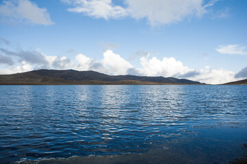 Lagoon high in the Andes of Peru, with mountains and blue sky in the background (Yauricocha Lagoon, Junin). Concept of nature.