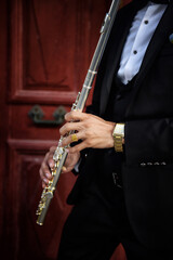 Standing Groom Holding Transverse Flute