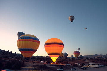 Colorful hot air balloons. Sunrise at Cappadocia. Bright colorful ballons ascending during sunrise in valley. Goreme, Nevsehir, Cappadocia
