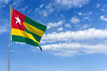 Togolese Republic Flag Over Blue Sky Background. 3D Illustration