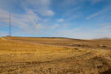 Landscape of Wind farm with wind turbines among plowed fields of Power County, Idaho