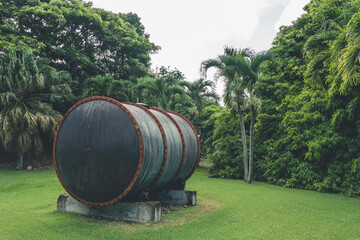 Big metal decorative barrel with rusted rings, used in distillery. Barrel as an exposition in a park