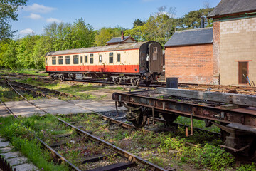 Obraz premium old and abandoned railway carriages and rail industry equipment in a disused railway yard