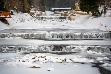 Frozen Elbe River in Spindleruv Mlyn in winter. Mountain town near Hradec Kralove, Czech republic