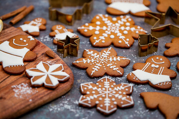 Christmas gingerbread cookies baking and decorating on kitchen table