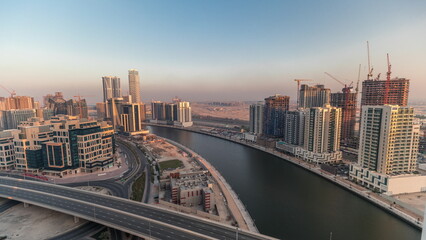 Fototapeta na wymiar Skyscrapers at the Business Bay aerial evening timelapse in Dubai, United Arab Emirates