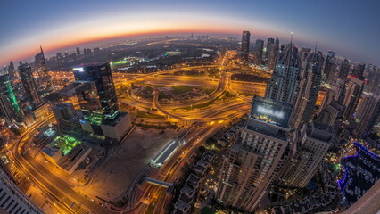 Fototapeta na wymiar Dubai marina and JLT skyscrapers along Sheikh Zayed Road aerial night to day timelapse.