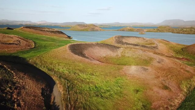 4K drone aerial footage over volcanic pseudo craters Skutustadagigar in lake Myvatn. Huge cones of pseudo craters on the Icelandic shore. Aerial of Skutustadagigar Pseudocrater Area in Iceland.
