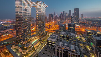 Obraz premium Futuristic Dubai Downtown and finansial district skyline aerial night to day timelapse.