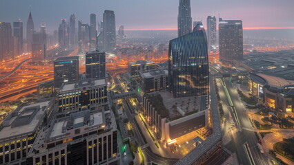 Fototapeta na wymiar Futuristic Dubai Downtown and finansial district skyline aerial night to day timelapse.