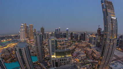 Fototapeta na wymiar Aerial panoramic view of a big futuristic city day to night timelapse. Business bay and Downtown
