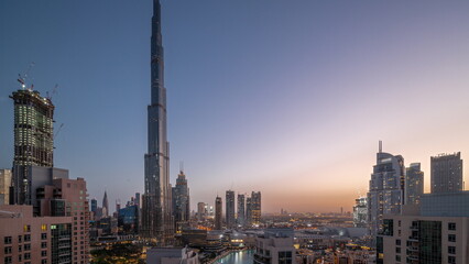 Obraz premium Dubai Downtown cityscape with tallest skyscrapers around aerial night to day timelapse.