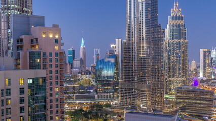 Aerial view of Dubai International Financial Centre district skyscrapers day to night timelapse