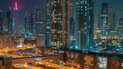 Fototapeta na wymiar Row of the tall buildings around Sheikh Zayed Road and DIFC district aerial night timelapse in Dubai