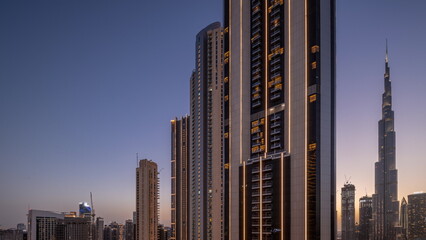 Tallest skyscrapers in downtown dubai located on bouleward street near shopping mall aerial day to night timelapse.