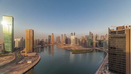 Cityscape skyscrapers of Dubai Business Bay with water canal aerial timelapse.