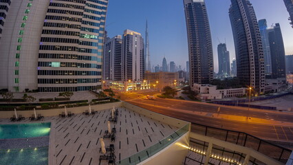 Aerial panorama of Dubai downtown and difc skyscrapers night to day timelapse.