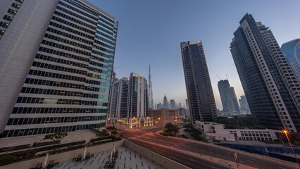 Fototapeta na wymiar Aerial panoramic looking up view to Dubai downtown and difc skyscrapers night to day timelapse.
