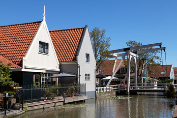 White drawbridge over the canal in the center of the picturesque Dutch village De Rijp in the Beemster.