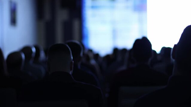 Back view of Audience listening speakers in the conference hall or seminar meeting, business and education about investment concept