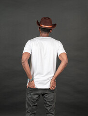 Back side image of an african man wearing white blank shirt with a hat, doing a simple pose