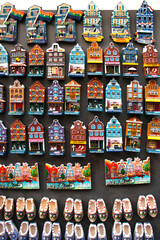 Fototapeta premium Souvenir shop window with magnets in Amsterdam There are a lot of magnets in the shape of old 'dancing' Amsterdam houses and clogs.
