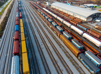 Freight depo with shipping containers and lots of railroad tracks aerial