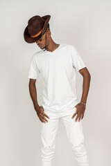 An african man wearing white blank shirt and a hat doing a simple pose