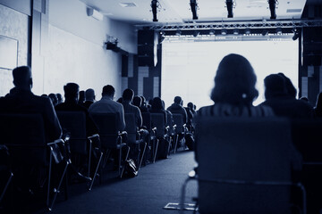 Back view of Audience listening speakers in the conference hall or seminar meeting, business and...