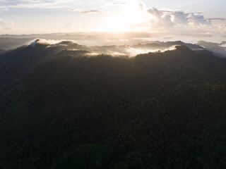 Sunrise illuminates clouds that drift over the Solomon Islands. This scenic region is known for its high marine biodiversity and World War II history.