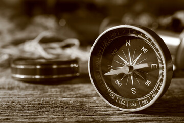 Fototapeta na wymiar Retro compass on dark wooden background, closeup