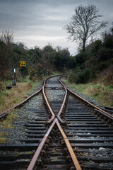 Old railway bifurcation in the countryside. Abandoned rail tracks. Northern Ireland, UK