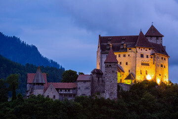 Fototapeta na wymiar Night view of illuminated medieval Gutenberg Castle on hilltop in Balzers village on summer, Liechtenstein