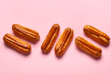 Sweet eclairs on pink background