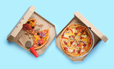 Cardboard boxes with tasty pizza on color background
