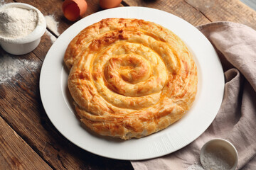 Plate with delicious cheese pie on wooden table