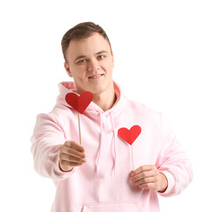 Young man with paper hearts for Valentine's Day on white background