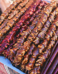 View of traditional armenian local candy sweets delights with churchkhela, sweet sausage, sudzhuk, dried fruits, walnuts and others for sale in a local vendor souvenir shop kiosk of Yerevan, Armenia