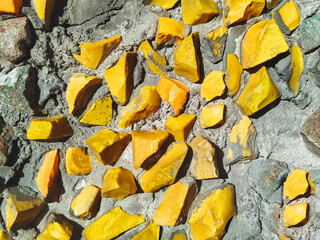 Abstract texture of yellow opaque glass. Fragment of a multi-colored matte mosaic from smalt of the USSR period.