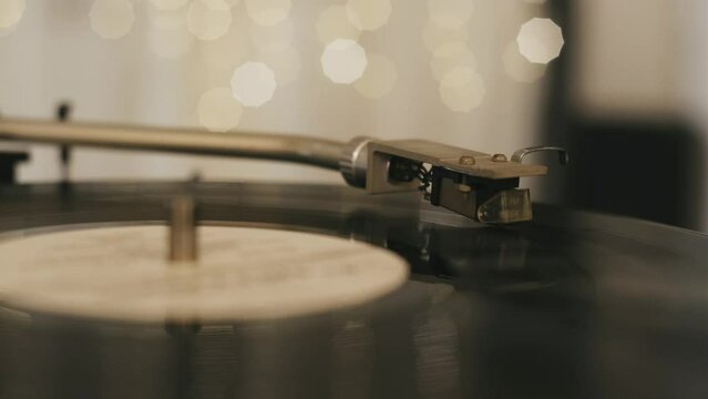 Vintage vinyl record close-up. Retro music player on living room home background with evening light
