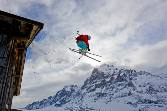 A young man skis off the roof of an alpine hut in Grindalwald, Switzerland.