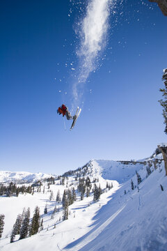 Man skiing powder, jumping, Wyoming