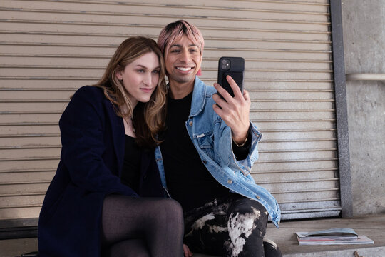  Lgbtqia friends sitting and posing together.