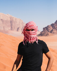 man in the desert with sand dunes